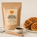 Bag of Heritage Waffle Mix with waffles and syrup on a white surface