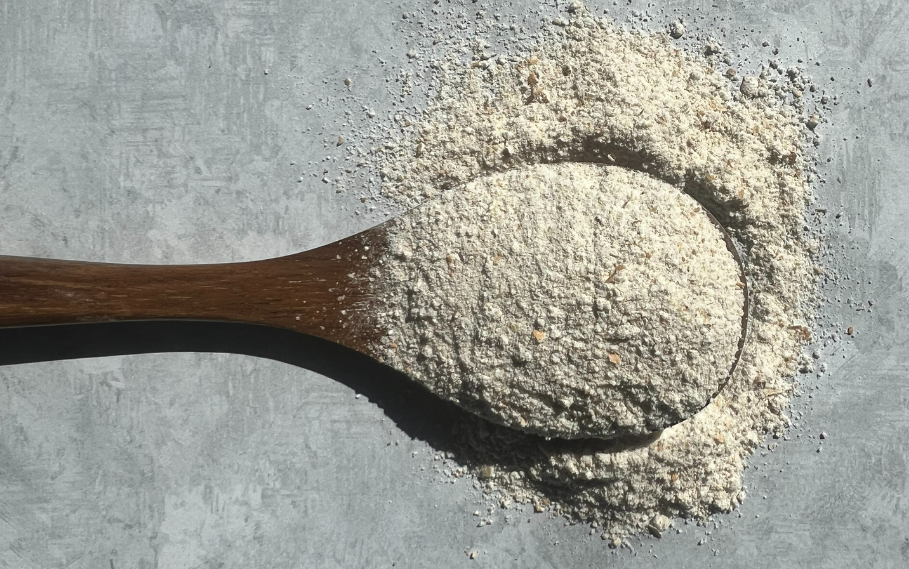 Wooden spoon filled with stone-ground flour